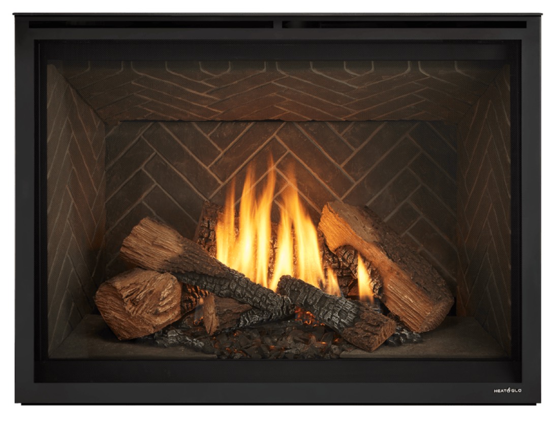 Heat & Glo 6000 gas fireplace with a herringbone firebox, lit.